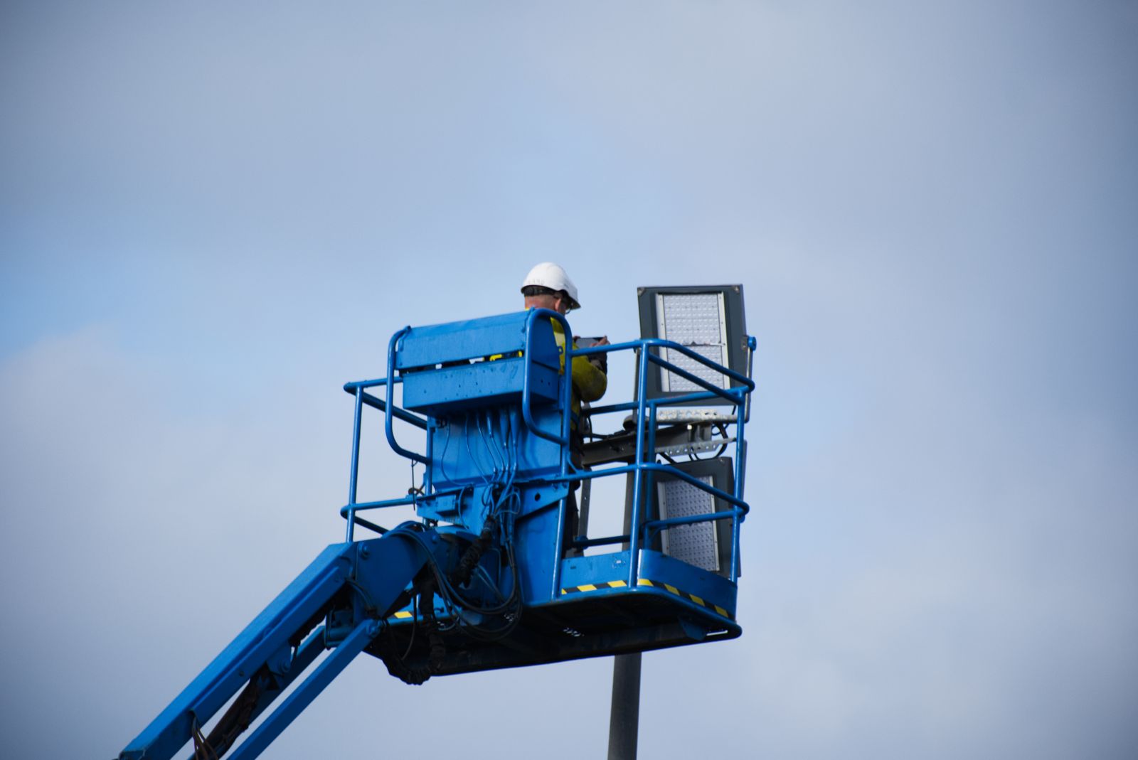 Professional using an aerial work platform during a technical field activity