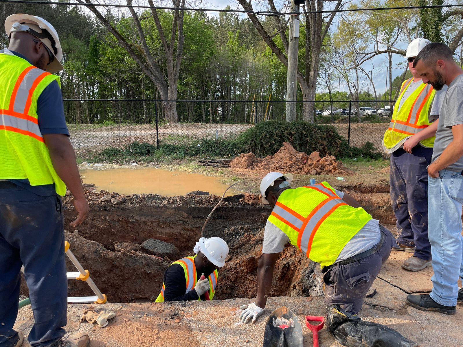 Construction team inspecting an underground infrastructure network